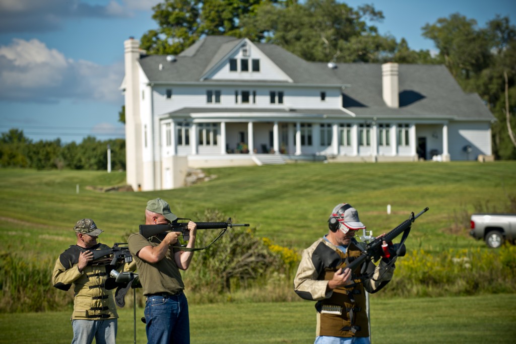 Lt. Col. John Cletus Paumier (center) takes aim with his AR-15 Rifle among friends on his own private 600-yard rifle range built in his back yard which spans eight acres of land in Salem, Ohio. Paumier not only designed the range, but he also designed the 4,000-square-foot home on the hill behind him. Paumier is an orthopedic surgeon, officer in charge of the Army Reserve Marksmanship Program and command surgeon for the 416th Theater Engineer Command, headquartered in Darien, Illinois. (U.S. Army photo by Sgt. 1st Class Michel Sauret)