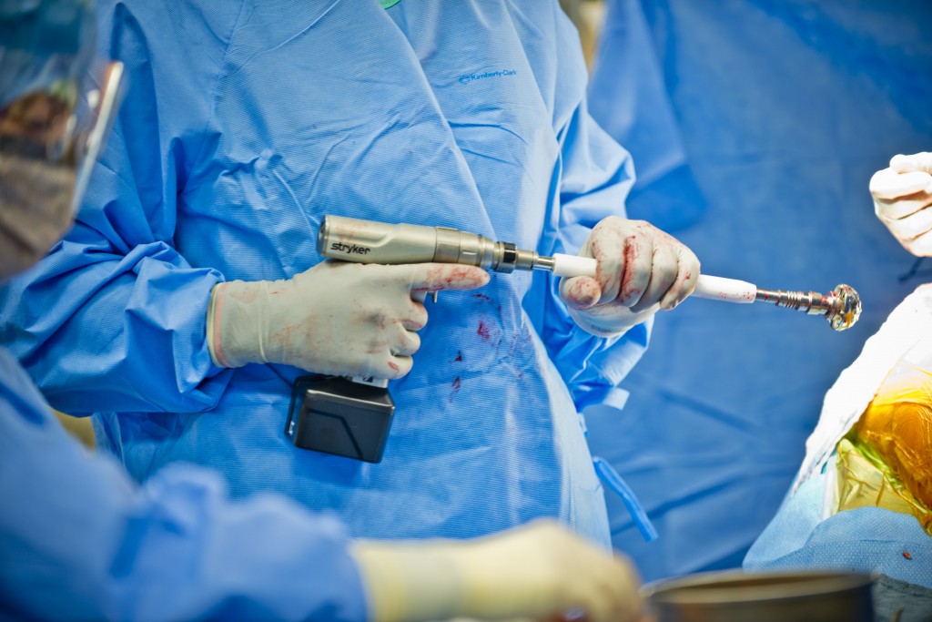 Lt. Col. John Cletus Paumier holds a grater reamer while performing hip replacement surgery at the Salem Regional Medical Center in Ohio. Paumier is an orthopedic surgeon, officer in charge of the Army Reserve Marksmanship Program and command surgeon to the 416th Theater Engineer Command, headquartered in Darien, Illinois. (U.S. Army photo by Sgt. 1st Class Michel Sauret)