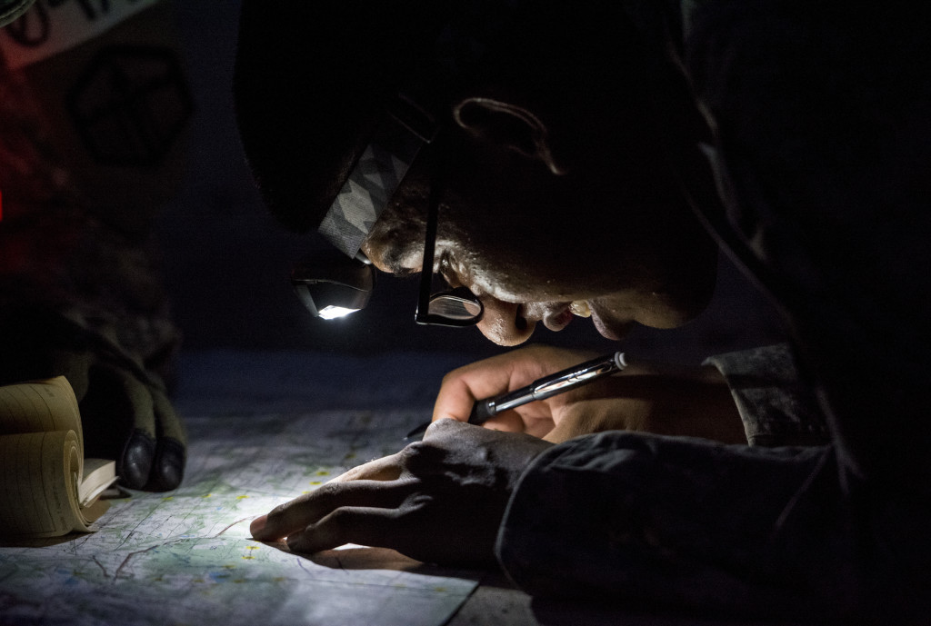 A U.S. Army Reserve combat engineer from the 374th Engineer Company (Sapper), of Concord, Calif., plots points on a map as the night sets in during a team-based land navigation course as part of the 2015 Sapper Stakes competition at Fort Chaffee, Ark., Aug. 30. The competition is designed to build teamwork, enhance combat engineering skills and promote leadership among the units.