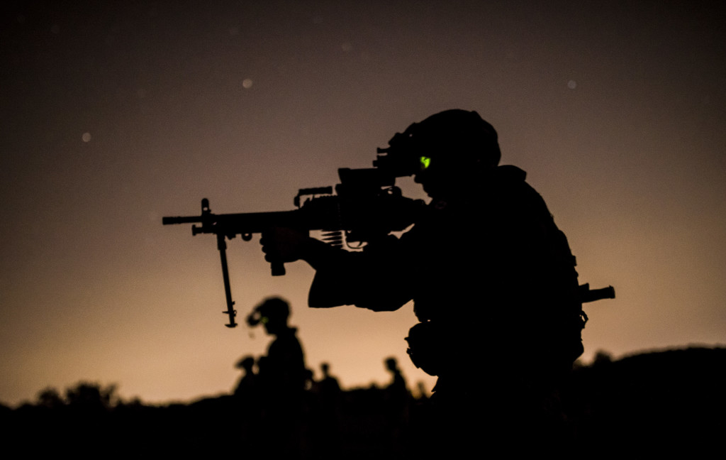 A Canadian Army soldier takes aim during a light machine gun night fire match during the 2015 Canadian Armed Forces Small Arms Concentration at the Connaught Range outside of Ottawa, Canada, Sept. 14. The marksmanship competition brought in more than 250 total competitors from the British, Canadian and U.S. armed forces competing in more than 50 matches involving rifle, pistol and light machine gun events using various combat-like movements and scenarios.