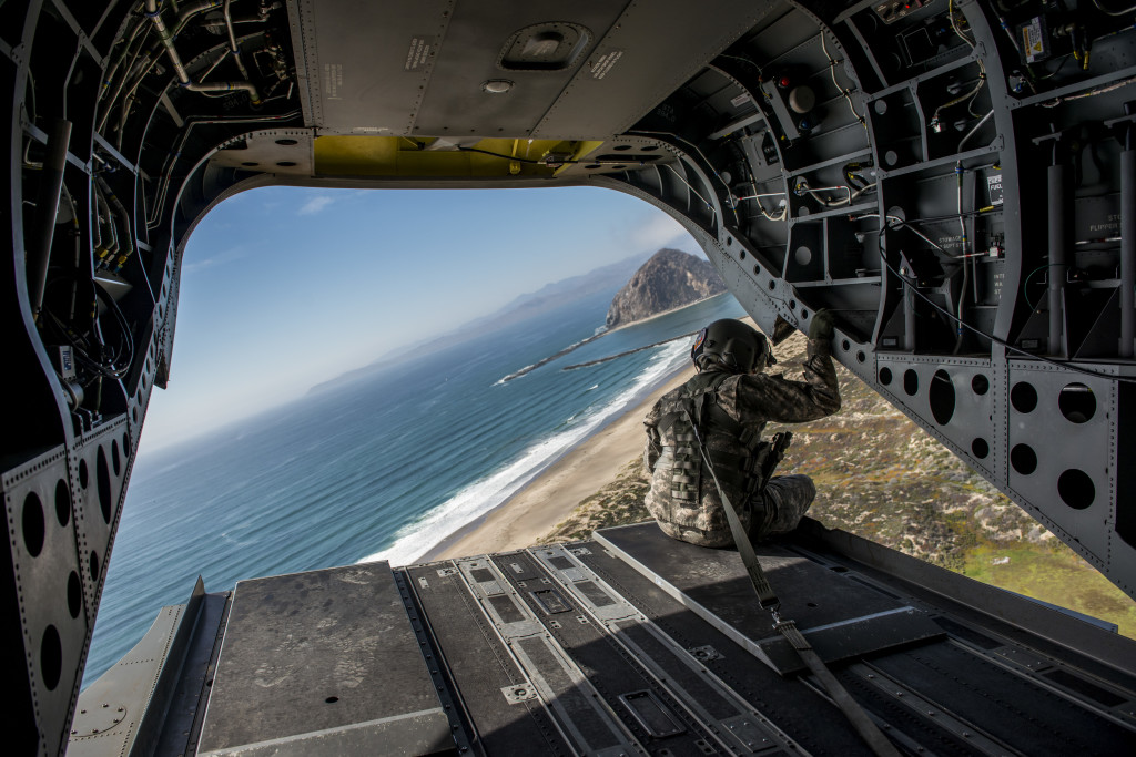 A California National Guard flight engineer looks out the back of a CH-47 Chinook during a rehearsal flyover for the 374th Engineer Company (Sapper) July 15 at Camp San Luis Obispo Military Installation, Calif. (U.S. Army photo by Master Sgt. Michel Sauret)