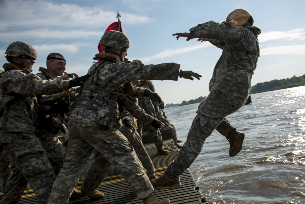Army Reserve Soldiers from the 310th Engineer Company (Multi-Role Bridge), from Fort A.P. Hill, Va., "baptize" 1st Lt. Shane Yingling, executive officer, into the Arkansas River during Operation River Assault 2015, a bridging training exercise involving Army Engineers and other support elements to create a modular floating bridge at Fort Chaffee, Ark., Aug. 4, using improved ribbon bridge bays. The entire training exercise lasted from July 28 to Aug. 4, 2015, involving one brigade headquarters, two battalions and 17 other units, to include bridging, sapper, mobility, construction and aviation companies. (U.S. Army photo by Master Sgt. Michel Sauret)