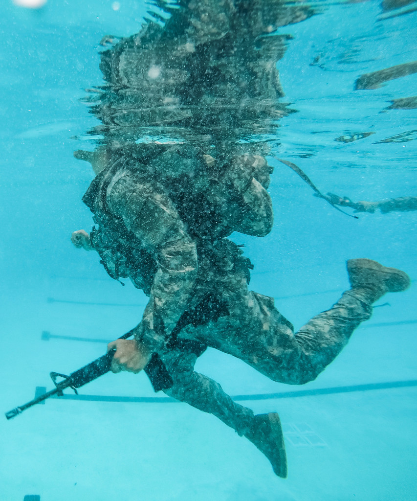 A U.S. Army Reserve combat engineer Soldier from the 374th Engineer Company (Sapper), headquartered in Concord, Calif., swims 25 meters with a ruck sack and a dummy rifle for a Combat Water Survival Training at Fort Hunter Liggett, Calif., July 17, during a two-week field exercise known as a Sapper Leader Course Prerequisite Training at Camp San Luis Obispo Military Installation, Calif. The unit is grading its Soldiers on various events to determine which ones will earn a spot on a "merit list" to attend the Sapper Leader Course at Fort Leonard Wood, Mo.