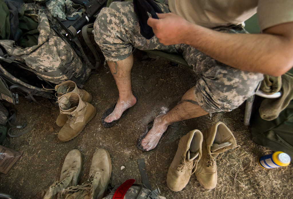 A U.S. Army Reserve combat engineer Soldier from the 374th Engineer Company (Sapper), headquartered in Concord, Calif., powders his feet after a long day of land navigation July 15 as part of a two-week field exercise known as a Sapper Leader Course Prerequisite Training in July at Camp San Luis Obispo Military Installation, Calif. The unit is grading its Soldiers on each event to determine which ones will earn a spot on a "merit list" to attend the Sapper Leader Course at Fort Leonard Wood, Mo.