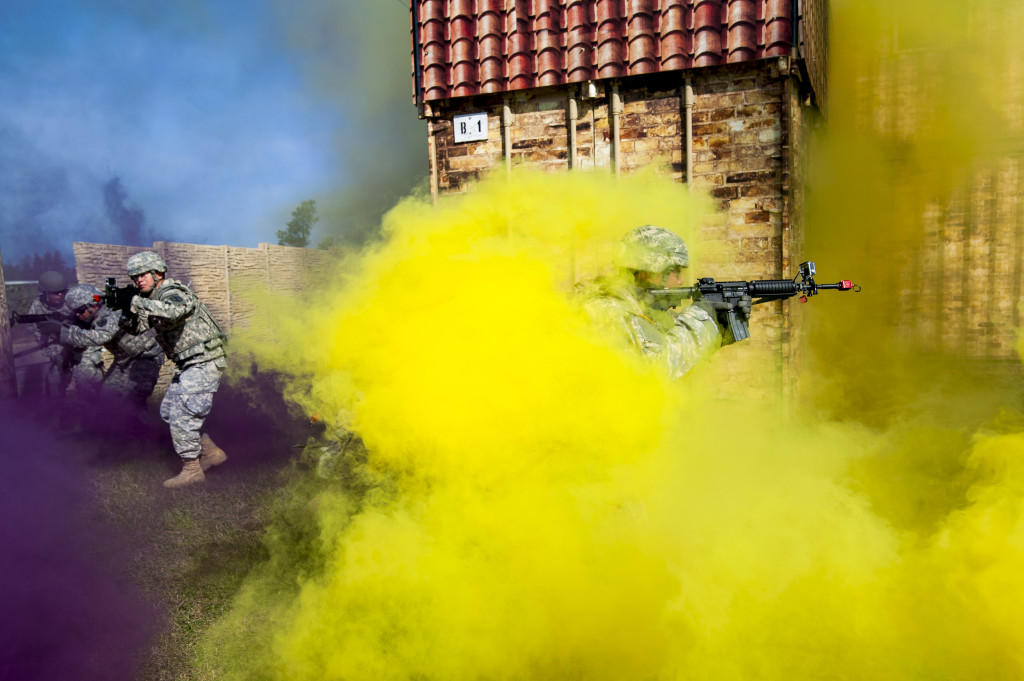 A team of Soldiers belonging to the 450th Engineer Company, the 350th Eng. Co., and the 374th Eng. Co., moves through concealing smoke to enter and clears a building as one of the evaluated exercises for Sapper Stakes at Fort McCoy, Wis., May 6. Sapper Stakes is a combined competition hosted by the 416th Theater Engineer Command and the 412th TEC to determine the best combat engineer team in the Army Reserve. (U.S. Army photo by Sgt. 1st Class Michel Sauret)