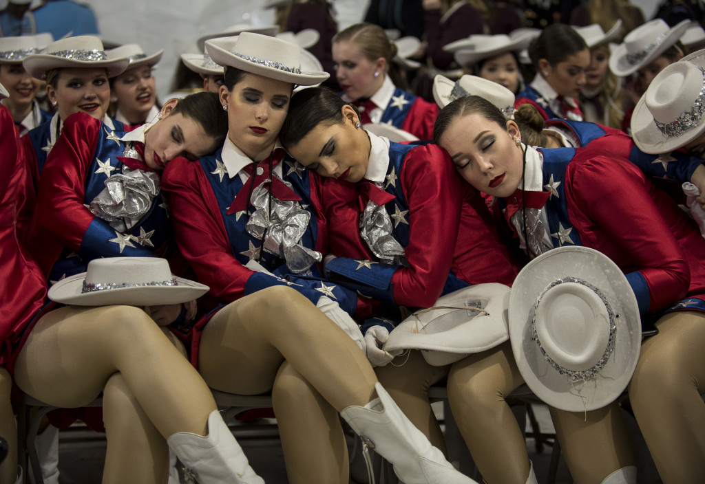 Raiders dancers from West Monroe High School, Louisiana, take a nap before the start of the 58th Presidential Inauguration Parade in Washington, D.C., on Jan. 20. The parade route stretched approximately 1.5 miles along Pennsylvania Avenue from the U.S. Capitol to the White House. (U.S. Army Reserve photo by Master Sgt. Michel Sauret)