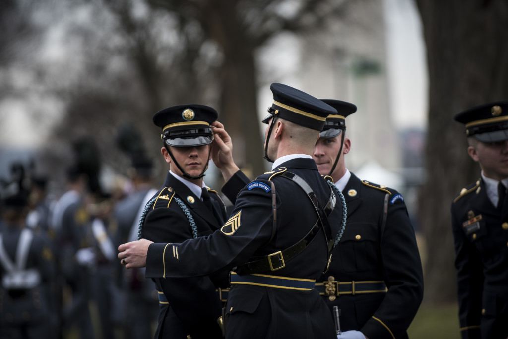 U.S. Army Soldiers from the 3rd Infantry Regiment (The Old Guard) make final adjustments to their uniforms before the start of the 58th Presidential Inauguration Parade in Washington, D.C., on Jan. 20. The parade route stretched approximately 1.5 miles along Pennsylvania Avenue from the U.S. Capitol to the White House. (U.S. Army Reserve photo by Master Sgt. Michel Sauret)